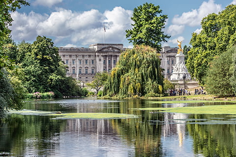 External view of Buckingham Palace across the lake